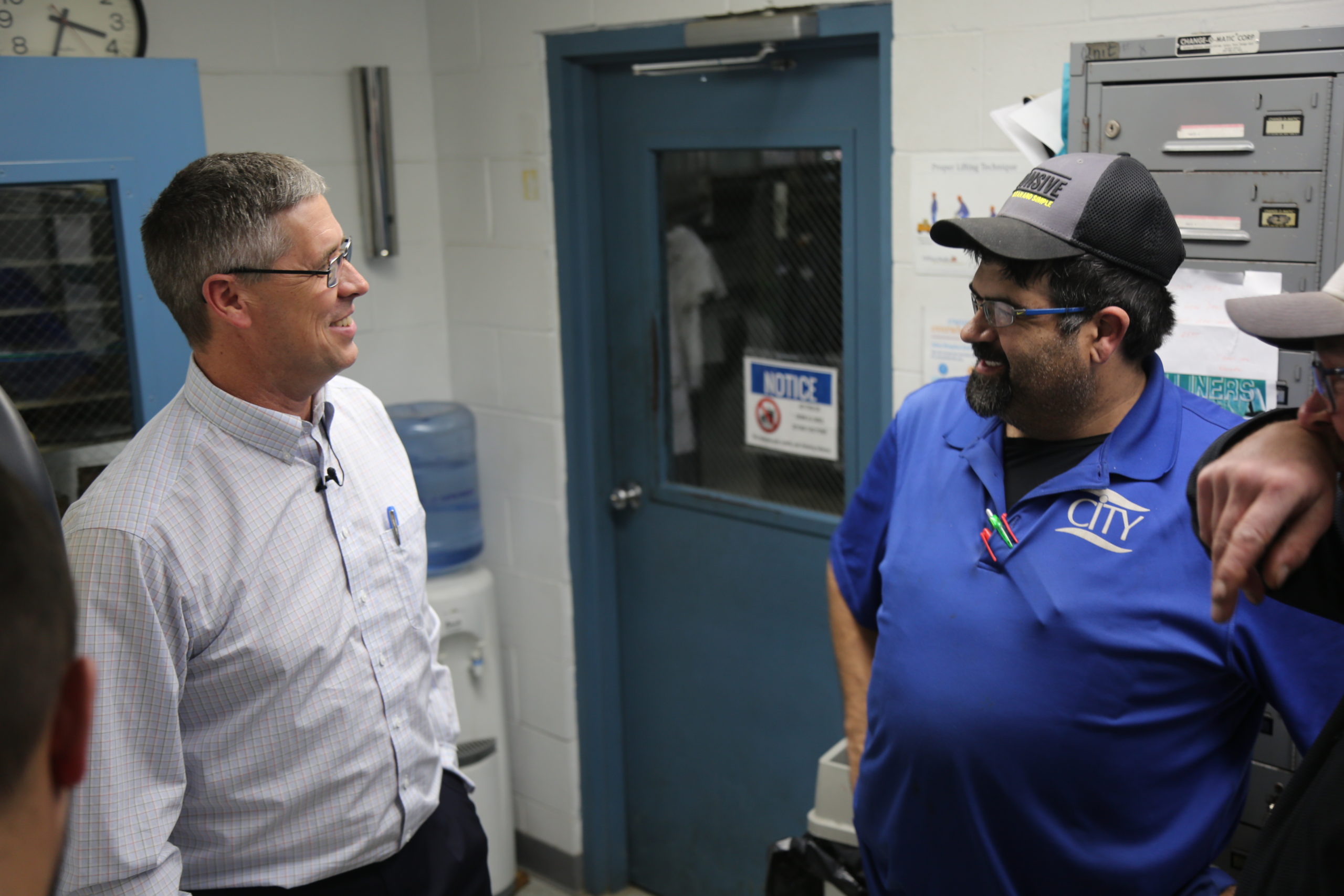 Director of Service Ken Schnor and Route Service Representative Derek Miller talk in CITY Laundering's Route Room